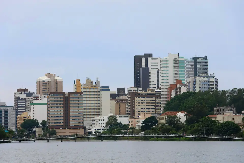 A large body of water with a city in the background — Gramado