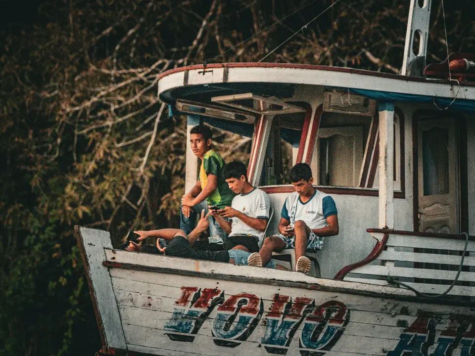 A group of people sitting on top of a boat — Manaus