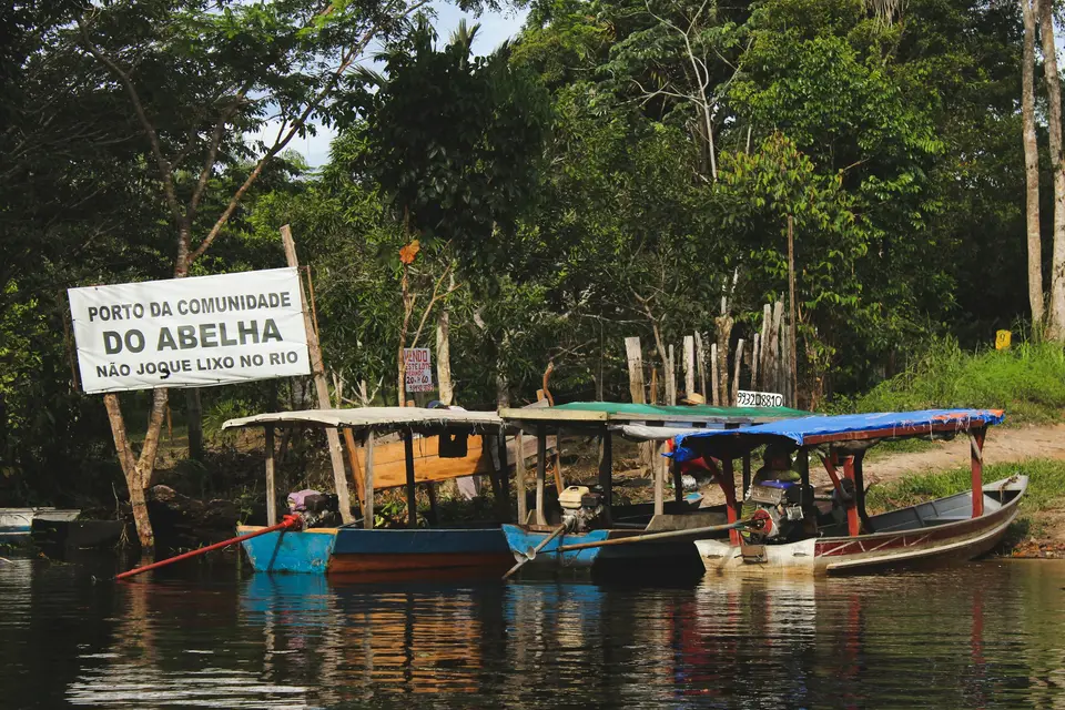 blue and white boat on body of water — Manaus