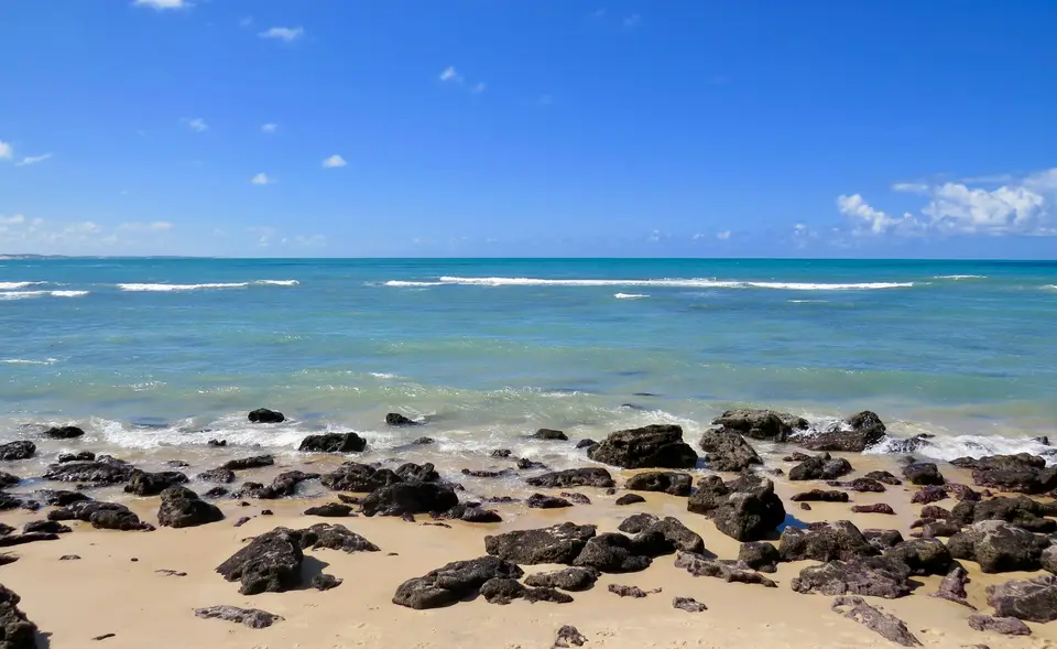brown rocks on seashore during daytime — Natal