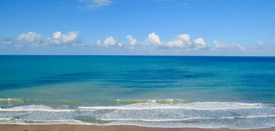 blue sea under blue sky and white clouds during daytime — Natal