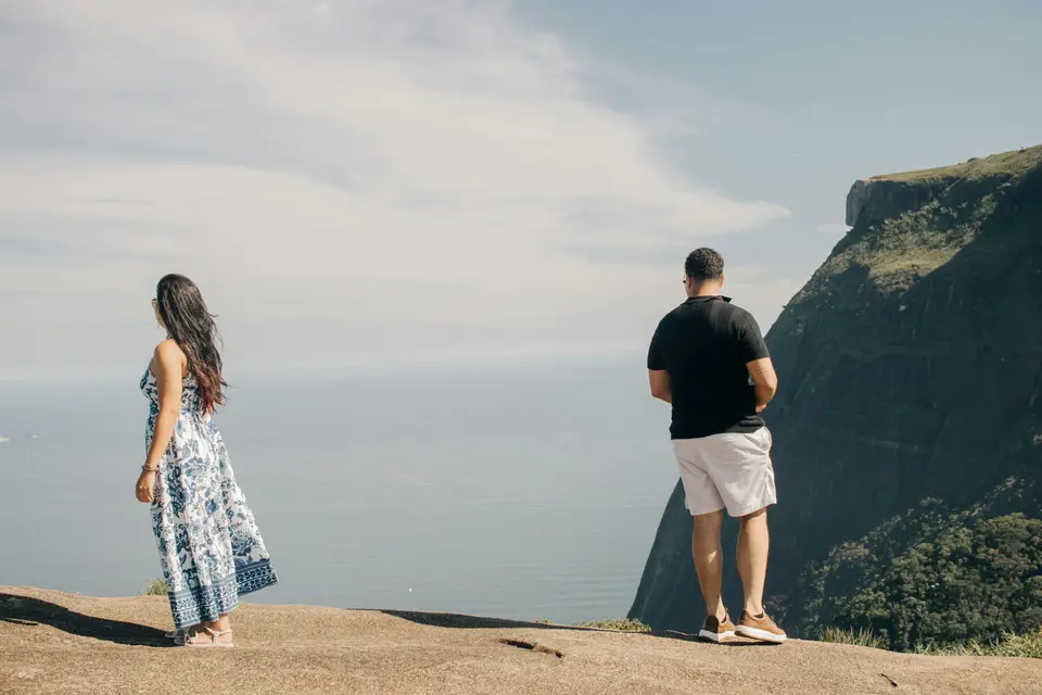 Couple standing on a cliff overlooking the ocean
